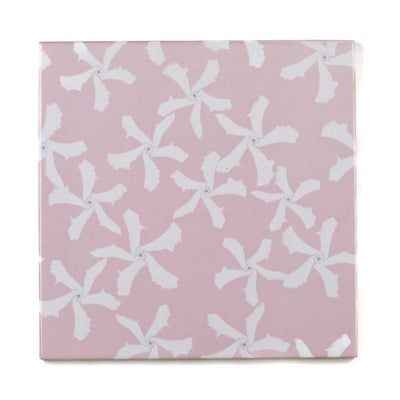 Pink ceramic tile with white floral pattern on a pink background