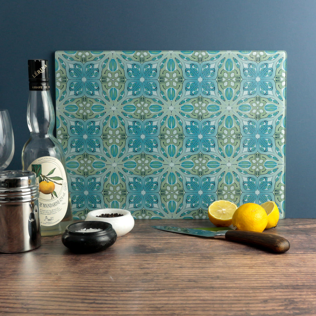 A pretty Art Deco blue-green glass trivet on a wooden worktop