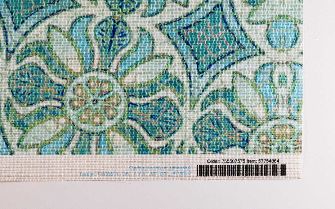 Close-up of a patterned fabric with blue and green design on a white background
